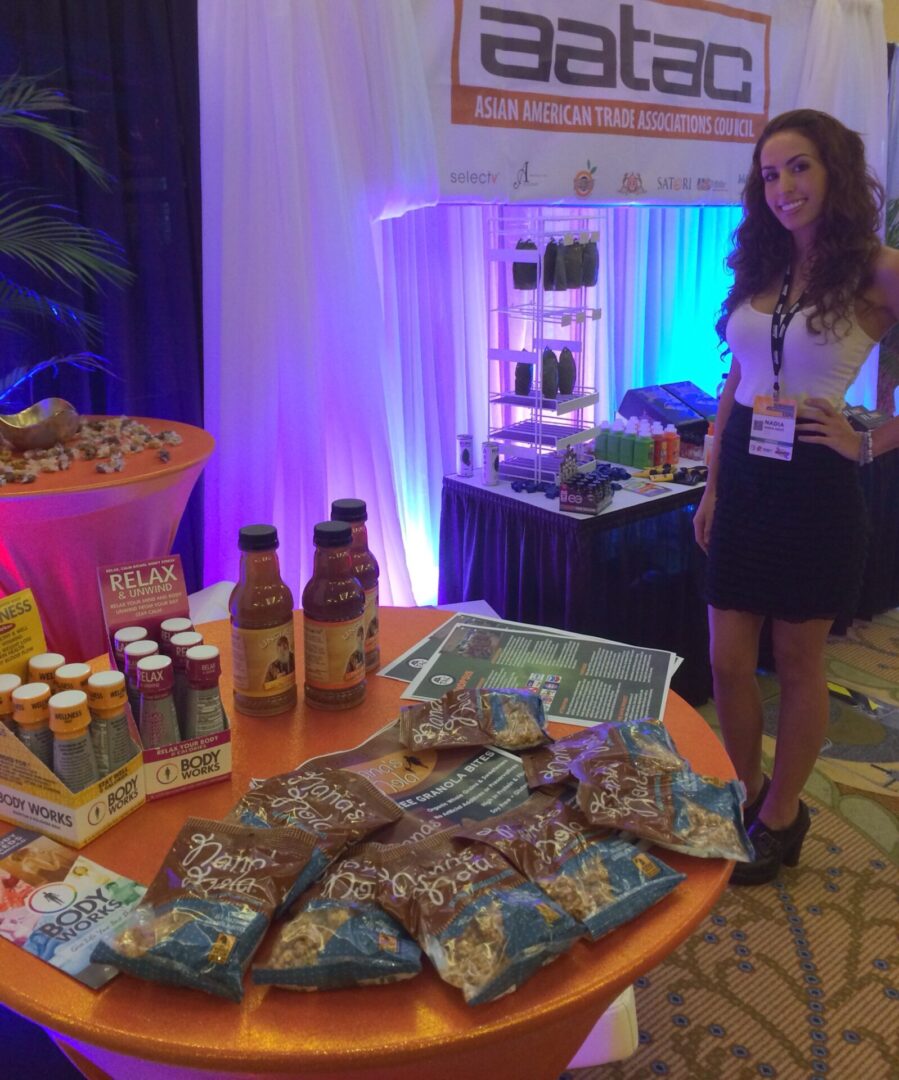 A woman standing in front of some food on a table