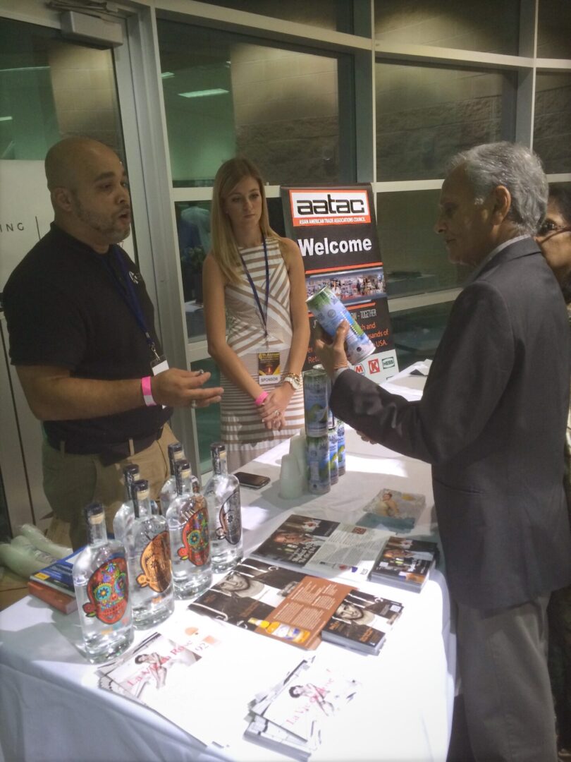 A man is talking to two people at a table.